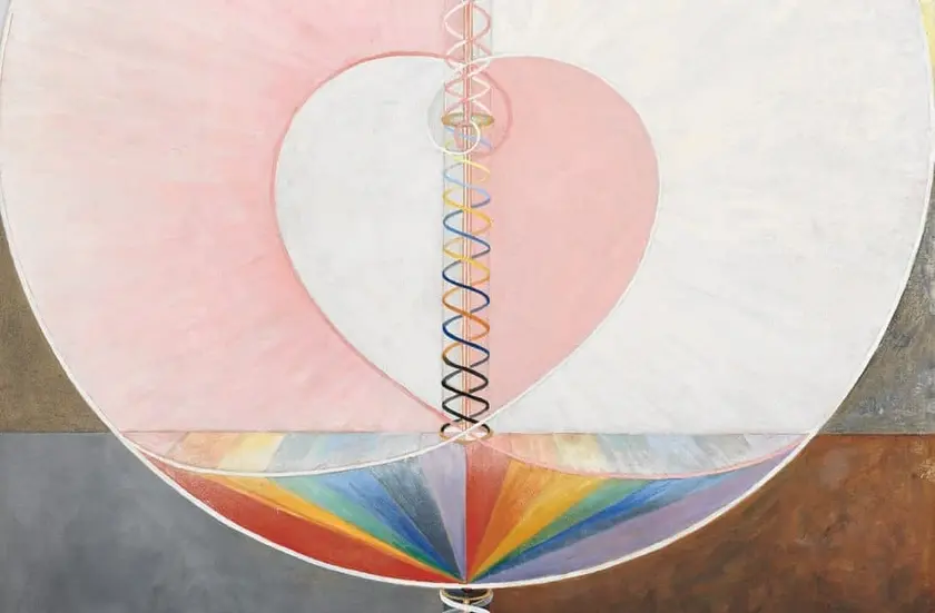 Un cercle divisé en sections avec un cœur rose au centre, entouré de motifs en spirale et de couleurs arc-en-ciel.